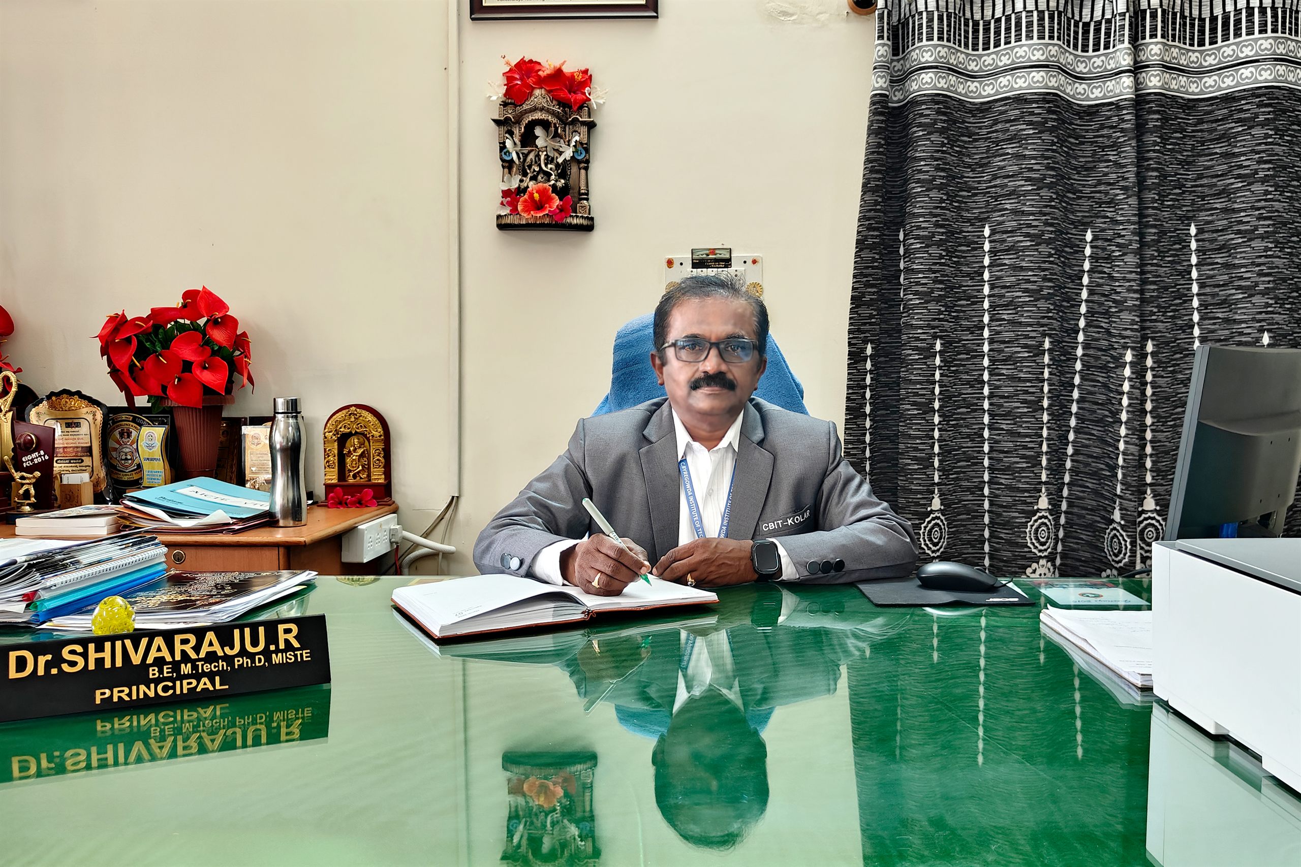 Dr. Shivaraju R, Principal, CBIT Kolar, at his desk